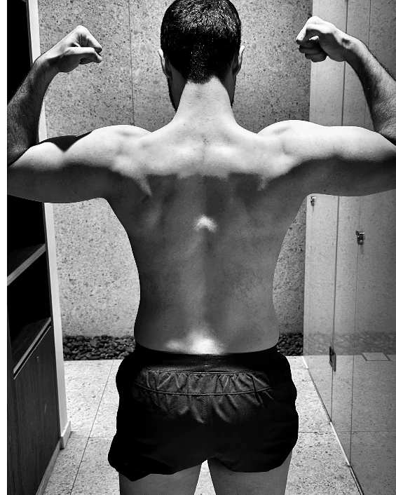 Client, back double-bicep, after 22 weeks of coaching