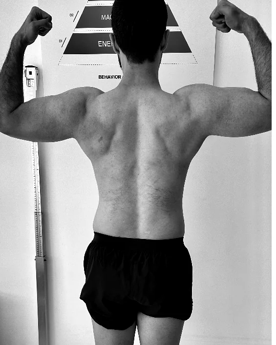 Client, back double-bicep, before coaching